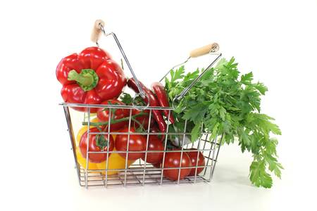 shopping basket with crisp vegetables on a bright backgroundの写真素材