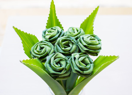 Roses, green crafts made from pandanus leaves.の写真素材