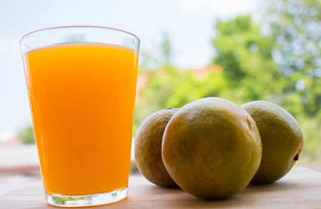 Oraorange juice with orange on wooden floorの写真素材