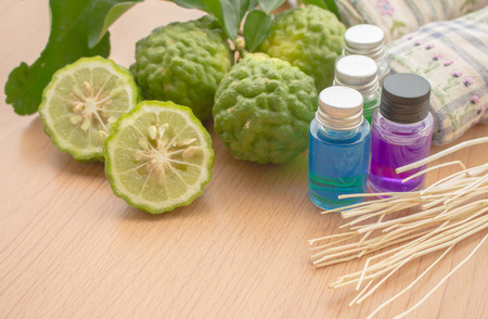 Oil in glass jar with fresh bergamot and towel on wooden floor for Sparの写真素材