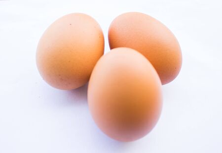 Fresh eggs laid on the white background.