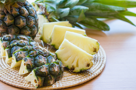 Fresh cut pineapple on a wooden floorの写真素材