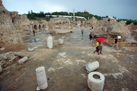 Antonine Baths  General view of Antonine Baths  Center of ruins under rainy and stormy weather with tourists who are visiting ruins のeditorial素材