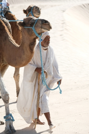 Douz, Kebili, Tunisia - September 17, 2012   Beduins leading tourists on camels at the Sahara desert on September 17, 2012 in Douz, Kebili, Tunisiaのeditorial素材