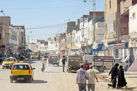 Kairouan, Tunisia -  September 16th, 2012   People on the streets of Kairouan, Tunisia  The streets of Kairouan are dusty with typical african buildings and bustle of people eveywhere のeditorial素材