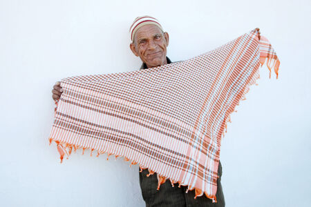 Kairouan,Tunisia - September 16th, 2012   An old Muslim man selling scarfs in the street of Kairouan, Tunisia のeditorial素材
