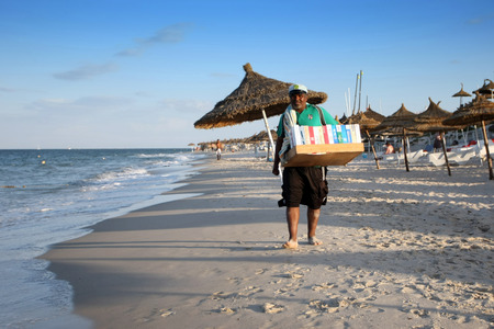 Sousse, Tunisia - September 15th, 2012   A local Tunisian selling cigarette on the beach of Sousse, Tunisia  In Tunisia, it is common that at a tourist places there are illegal traders with a variety of goods that they sell bargaining with you のeditorial素材
