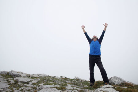 A man spreading hands on top of the mountain called Grobnicke Alpe in Grobnik, Rijeka, Croatia 