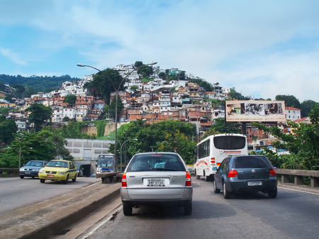 RIO DE JANEIRO - APRIL 4   Traffic in front of the tunnel Andre Reboucas that passes by one of the many favelas on April 4th, 2006 in Rio de Janeiro, Brazil のeditorial素材