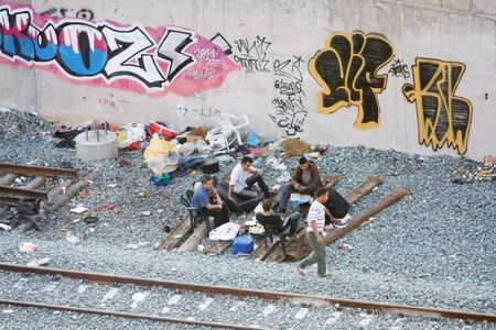 ATHENS, GREECE - OCTOBER 5 : A group of local men hanging out by the railway on October 5th, 2011 in Athens, Greece.のeditorial素材