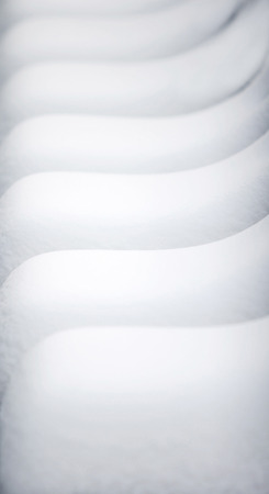 An abstract background of lines made of chairs covered in snow.