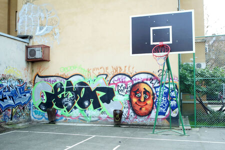 ZAGREB, CROATIA - FEBRUARY 24 : Basketball yard with broken basketball hoop and walls covered in graffiti on February 24th, 2014 in Zagreb, Croatia.のeditorial素材