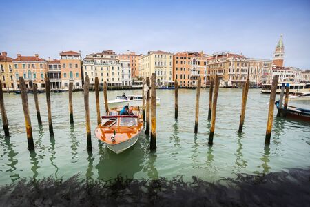 VENICE, ITALY - FEBRUARY 15 : A boat parked at a gondola dock in a grand canal with St Markのeditorial素材