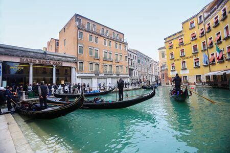 VENICE, ITALY - FEBRUARY 15 : Tourists and gondolas at a gondola station next to Hard rock cafe and Hotel Cavalletto on February 15th, 2014 in Venice, Italy.のeditorial素材
