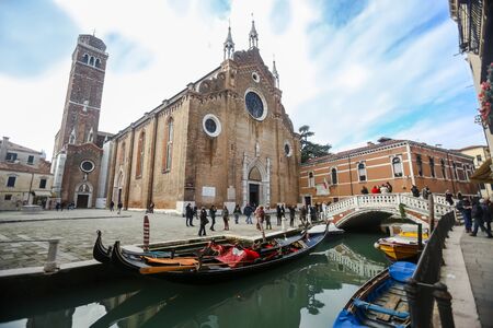 VENICE, ITALY - FEBRUARY 15 : A view of gondolas moored in the water canal in front of the Basilica di Santa Maria Gloriosa dei Frari on the square Campo dei Frari on February 15th, 2014 in Venice, Italy.のeditorial素材