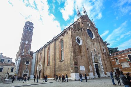 VENICE, ITALY - FEBRUARY 15 : People walking on the square Campo dei Frari in front of the Basilica di Santa Maria Gloriosa dei Frari on February 15th, 2014 in Venice, Italy.のeditorial素材