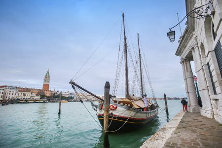 VENICE, ITALY - FEBRUARY 15 : A moored sailing boat in the grand canal with a view of the San Marco bell tower in the background on February 15th, 2014 in Venice, Italy.のeditorial素材