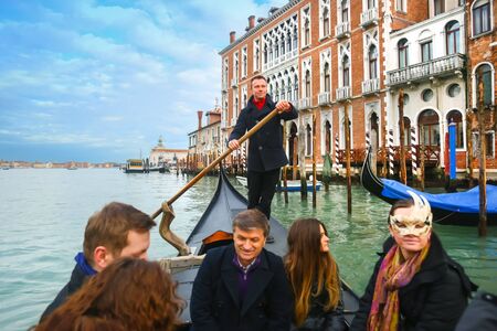 VENICE, ITALY - FEBRUARY 15 : A front view of the inside of the gondola with gondolier and tourists sailing in the grand canal on February 15th, 2014 in Venice, Italy.のeditorial素材