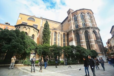 VENICE, ITALY - FEBRUARY 15 : People walking in front of the Basilica di Santa Maria Gloriosa dei Frari on February 15th, 2014 in Venice, Italy.のeditorial素材