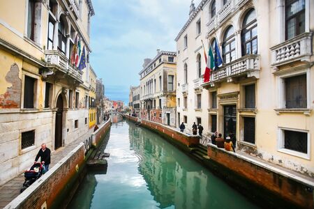VENICE, ITALY - FEBRUARY 15 : A view of people walking in the sidewalks of a empty water canal on February 15th, 2014 in Venice, Italy.のeditorial素材