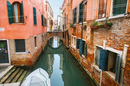 VENICE, ITALY - FEBRUARY 15 :A view of a water canal with people walking over the bridge on February 15th, 2014 in Venice, Italy.のeditorial素材