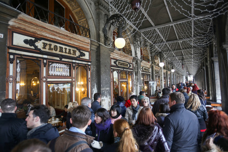 VENICE, ITALY - FEBRUARY 15 : A large group of people walking in front of Caffe Florian in Procuratie Nuove on Piazza San Marco on February 15th, 2014 in Venice, Italy.のeditorial素材