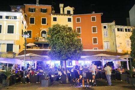 ROVINJ CROATIA  AUGUST 6 : People sitting on terrace of a night club on the promenade on August 6th 2013 in Rovinj Croatia. Rovinj is a tourist destination on Adriatic coast of Croatia.のeditorial素材