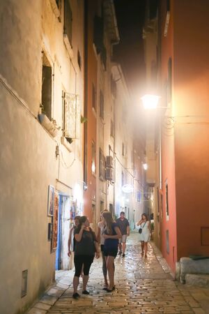 ROVINJ CROATIA  AUGUST 6 : People walking in a narrow street at night on August 6th 2013 in Rovinj Croatia. Rovinj is a tourist destination on Adriatic coast of Croatia.のeditorial素材