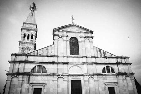 A low angle view of the Saint Euphemia church and bell tower in Rovinj Croatia. Rovinj is a touristic destination on Adriatic coast of Croatia.の写真素材