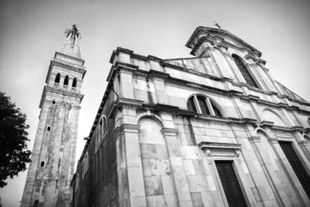 A low angle view of the Saint Euphemia church and bell tower at sunset in Rovinj, Croatia. Rovinj is a tourist destination on Adriatic coast of Croatia.の写真素材