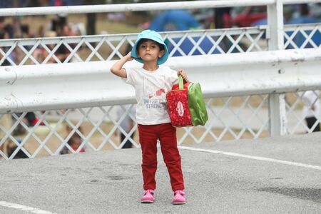 BELGRADE, SERBIA - SEPTEMBER 5 : A small syrian refugee girl in a park full of refugees waiting for the transport to the European Union on September 5th, 2015 in Belgrade, Serbia.のeditorial素材