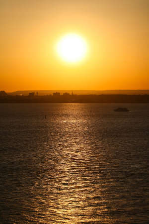 New Jersey waterfront at sunset viewed from the Upper New York Bay in New Jersey, USA.の写真素材