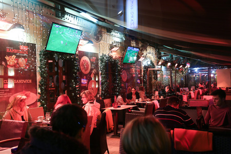 ZAGREB, CROATIA - DECEMBER 13: People sitting in a decorated coffee shop at Advent time on December 13th, 2015 in Zagreb, Croatia. Zagreb has been declared the best european christmas destination in 2015.のeditorial素材