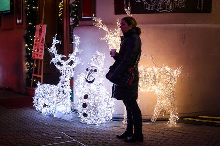 ZAGREB, CROATIA - DECEMBER 14: A woman standing in front of the christmas decoration in Bogoviceva street at advent time on December 14th, 2015 in Zagreb, Croatia. Zagreb has been declared the best european christmas destination in 2015.のeditorial素材