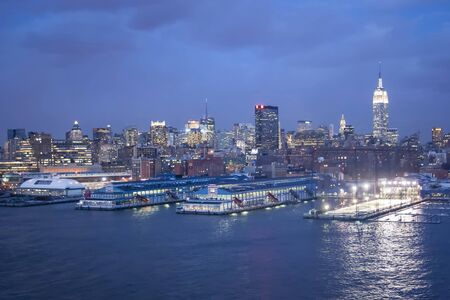 NEW YORK CITY, USA - MARCH 9 : A view of the panorama of Midtown Manhattan coast with Chelsea piers sports and entertainment complexat at sunset on March 9th, 2005 in New York City, USA.のeditorial素材