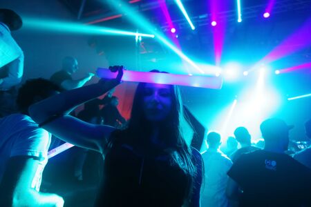 ZAGREB, CROATIA - APRIL 9, 2016 : A woman from the audience with an illuminating stick posing on La Fiesta Stage by Sensation party in Hypo center in Zagreb, Croatia.のeditorial素材