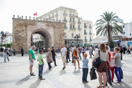 TUNIS, TUNISIA - SEPTEMBER 14, 2012 : People in the city square Place de la Victoire with gate called Bab El Bhar in Tunis, Tunisia.のeditorial素材