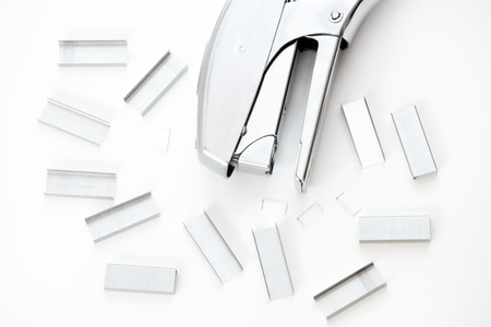 A top view of a staple and a group of staples arranged on white background.の写真素材