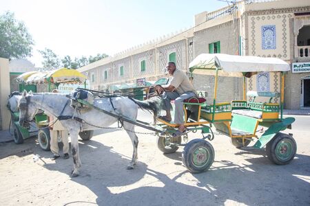 TUNIS, TUNISIA - SEPTEMBER 16, 2012 : A muslim man sitting in an empty tourist carriage and waiting for tourist to arrive in Tozeur, Tunisia.のeditorial素材