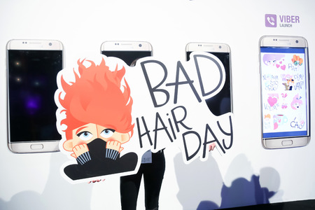 ZAGREB, CROATIA- OCTOBER 11, 2016 : Hostess holding Bad hair day sticker on presentation of Fashion.hr Viber Stickers on Bipa Fashion.hr in Zagreb, Croatia.のeditorial素材