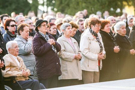 VELIKA GORICA, CROATIA - NOVEMBER 1, 2016 : A large group of people praying at a mass at cemetery on All Saints day in Velika Gorica, Croatia.のeditorial素材