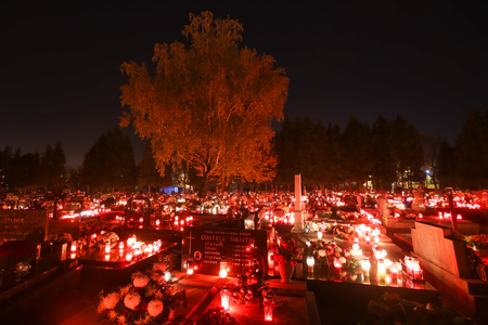 VELIKA GORICA, CROATIA - NOVEMBER 1, 2016 : A night view of ornated graves with flowers and burning lampions at cemetery on All Saints day in Velika Gorica, Croatia.のeditorial素材