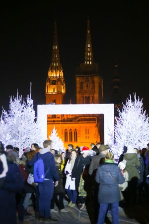 ZAGREB, CROATIA - DECEMBER 1th, 2016: Advent time in city center of Zagreb,Croatia.People in the Gradec, old town taking photos in the Advent photo frame overlooking the city and the Zagreb cathedral.のeditorial素材