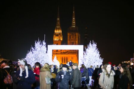 ZAGREB, CROATIA - DECEMBER 1th, 2016: Advent time in city center of Zagreb,Croatia.People in the Gradec, old town taking photos in the Advent photo frame overlooking the city and the Zagreb cathedral.のeditorial素材
