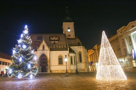 ZAGREB, CROATIA - DECEMBER 1, 2016: Advent time in city center of Zagreb,Croatia. The illuminating Christmas trees in front of the Saint Marks Church at St. Mark's Square in the upper old town Gradec.のeditorial素材