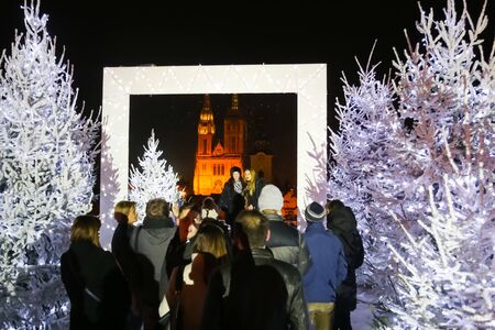 ZAGREB, CROATIA - DECEMBER 1th, 2016: Advent time in city center of Zagreb,Croatia.People in the Gradec, old town taking photos in the Advent photo frame overlooking the city and the Zagreb cathedral.のeditorial素材