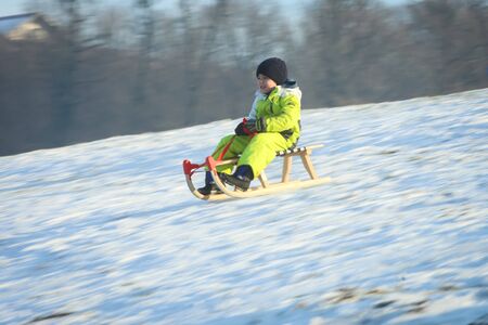ZAGREB, CROATIA - JANUARY 15, 2017 : A child sledding down the hill at winter time in Zagreb, Croatia.のeditorial素材
