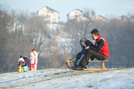 ZAGREB, CROATIA - JANUARY 15, 2017 : Two boys sledding down the hill at winter time in Zagreb, Croatia.のeditorial素材