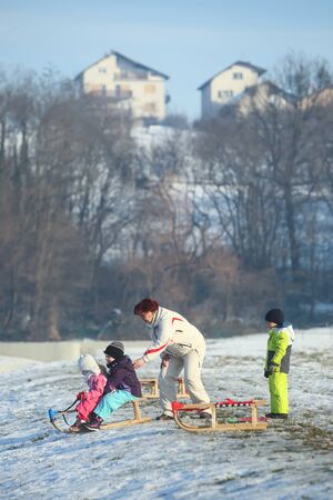 ZAGREB, CROATIA - JANUARY 15, 2017 : Children sledding down the hill in the presence of an adult woman at winter time in Zagreb, Croatia.のeditorial素材