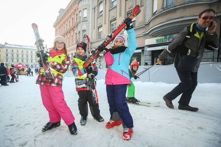 ZAGREB, CROATIA - JANUARY 15, 2017 : FIS World Snow Day for kids with free skiing and snowboarding lessons on the ski slope in Bakaceva street, on the road from the cathedral to the main square. Three kids posing with skis in their hands.のeditorial素材